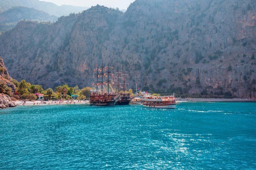A coastal scene with two ships, one with a tall mast, and a mountainous backdrop. 2