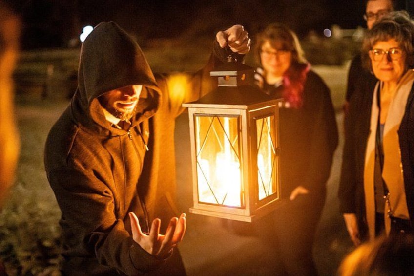 A person holding a lantern at night. 3