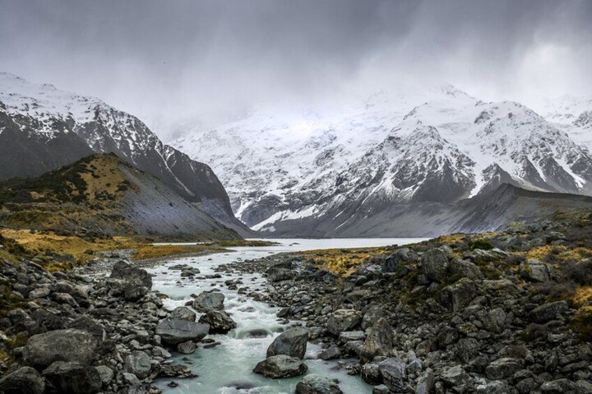 A glacier lake surrounded by snow-covered mountains. 2