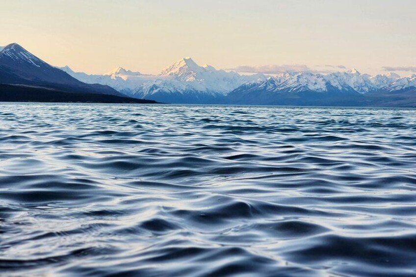 A calm lake with snow-capped mountains in the background. 3