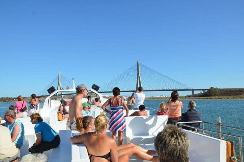 A boat with people on a bridge in the background. 2
