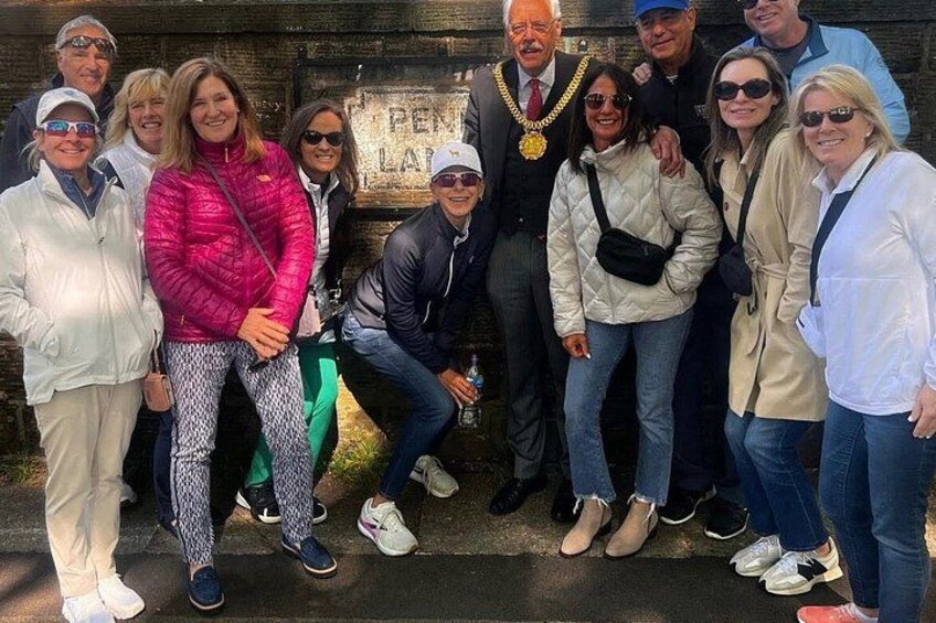 A group of people posing in front of a sign that reads 'PENNA LAGH.' 3