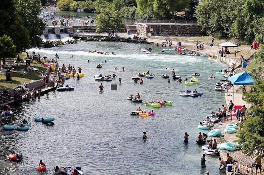 A river with people rafting and swimming. 1