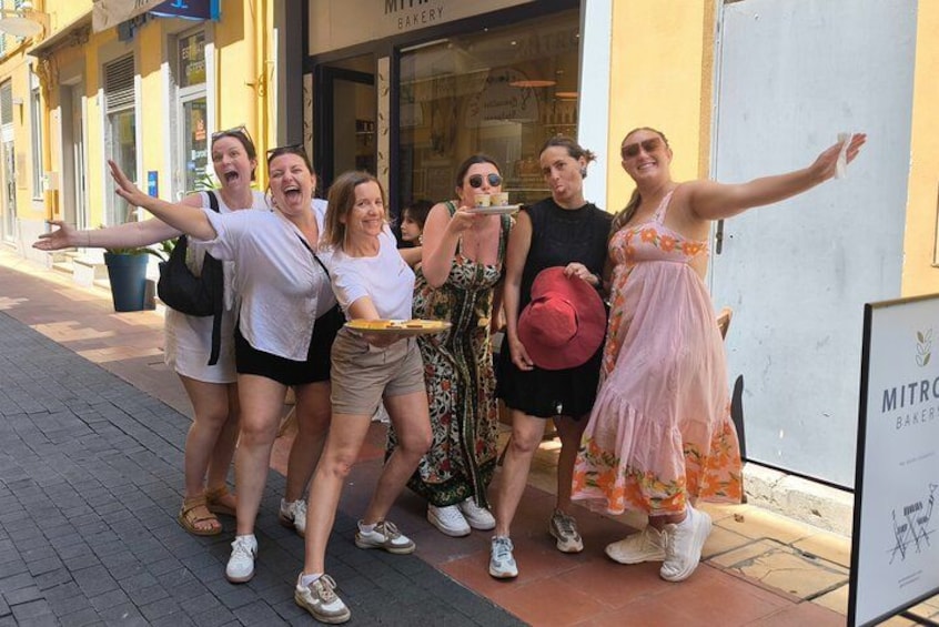A group of people posing on a city sidewalk. 2