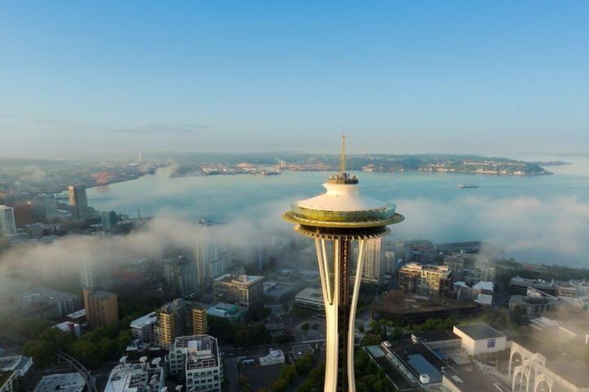 A cityscape with a prominent tower, a body of water, and surrounding buildings. 3