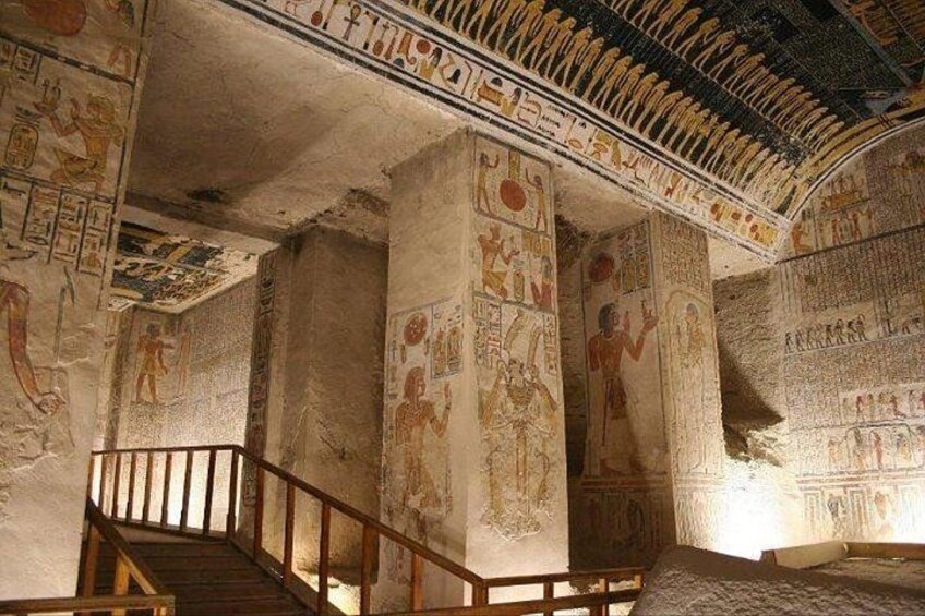 An ancient Egyptian temple interior with hieroglyphs, columns, and a staircase. 3