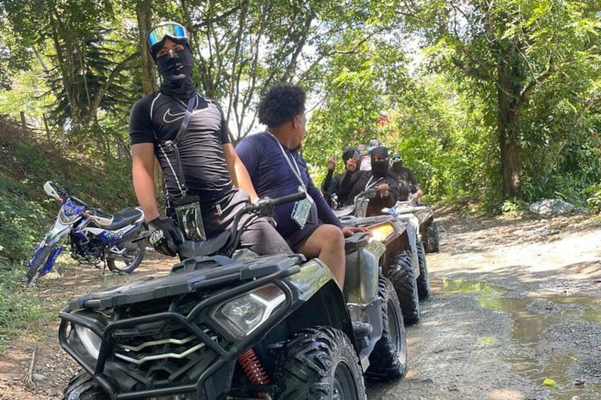 A group of people on all-terrain vehicles in a forested area. 4