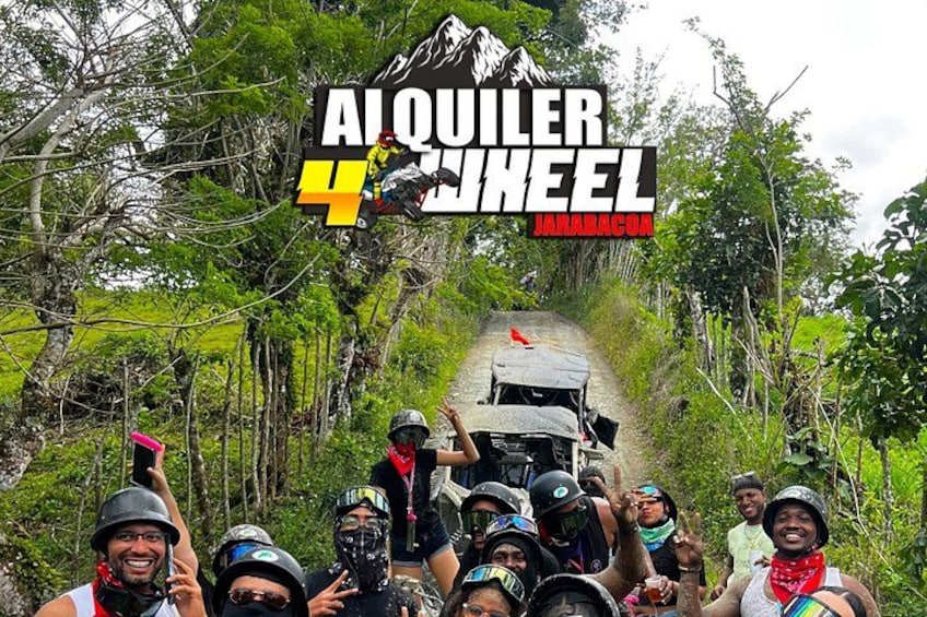 A group of people on a dirt road surrounded by trees, with a vehicle in the background. 3