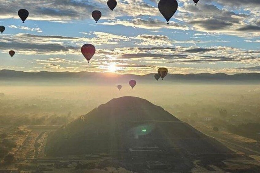 Hot air balloons, a mountain, and a sunrise. 2