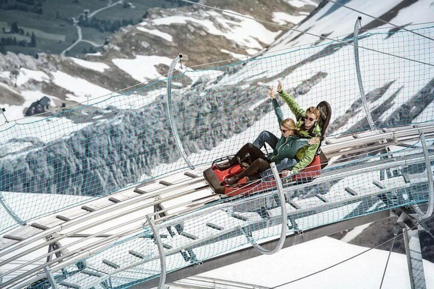 A person on a zip line over a snowy landscape. 3