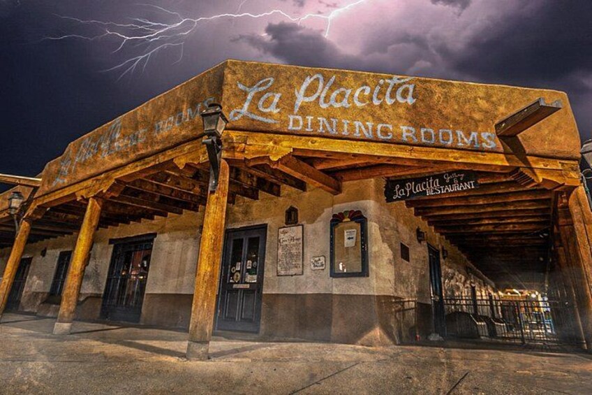 La Placita, un restaurant au décor rustique, avec une façade pittoresque et un ciel orageux en toile de fond. 1