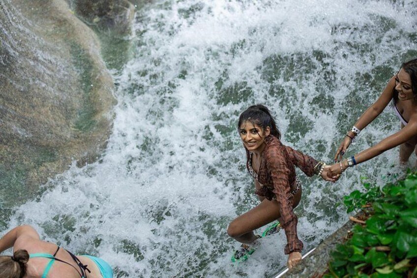 A waterfall with people enjoying the water. 4