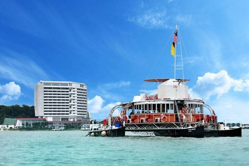 A ferry with an American flag, docked at a port with a tall building in the background. 5