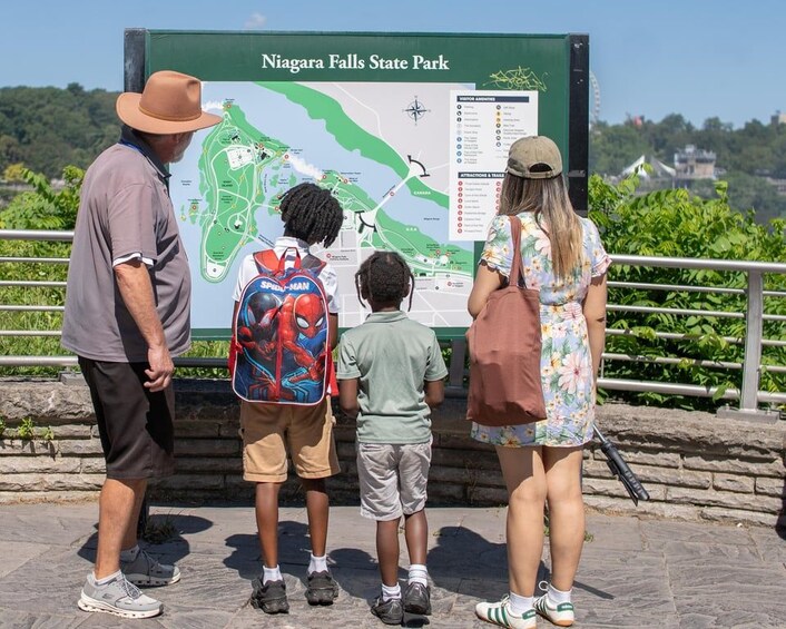 A family looking at a map at Niagara Falls State Park. 3