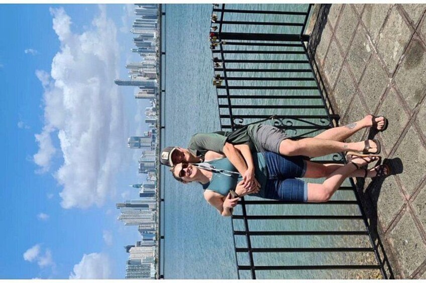 A person standing on a bridge with a city skyline in the background. 2