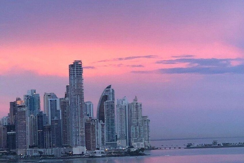 A city skyline with high-rise buildings and a body of water in the foreground. 5