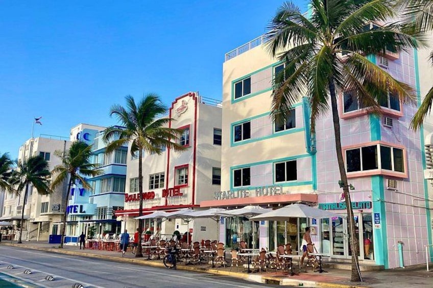 A street with palm trees, a Balmyard Hotel, and a bar. 4