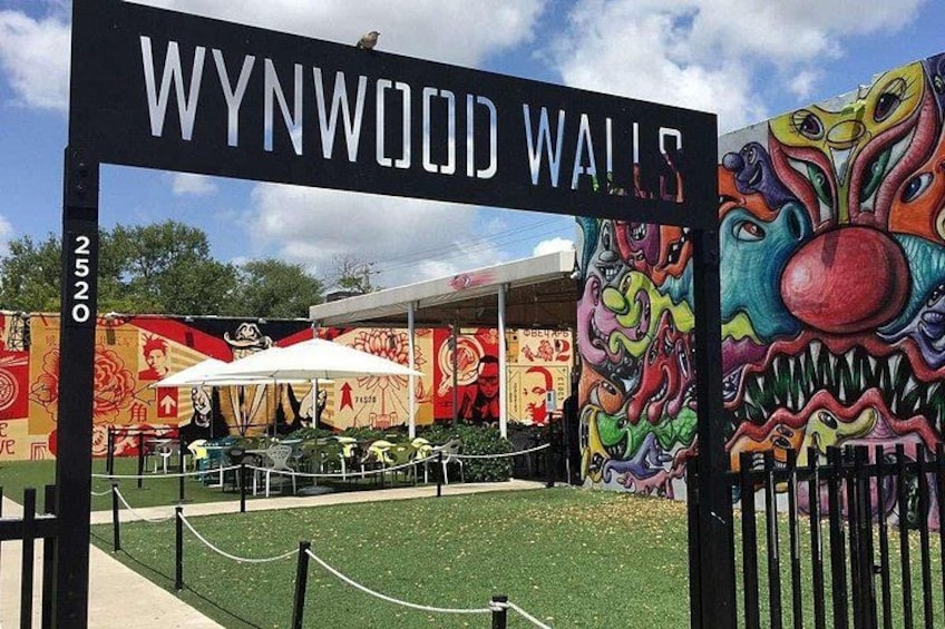 Wynwood Walls with colorful murals, outdoor seating, and a clear sky. 5