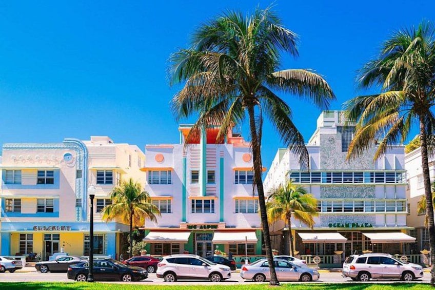A colorful building with palm trees in front. 3