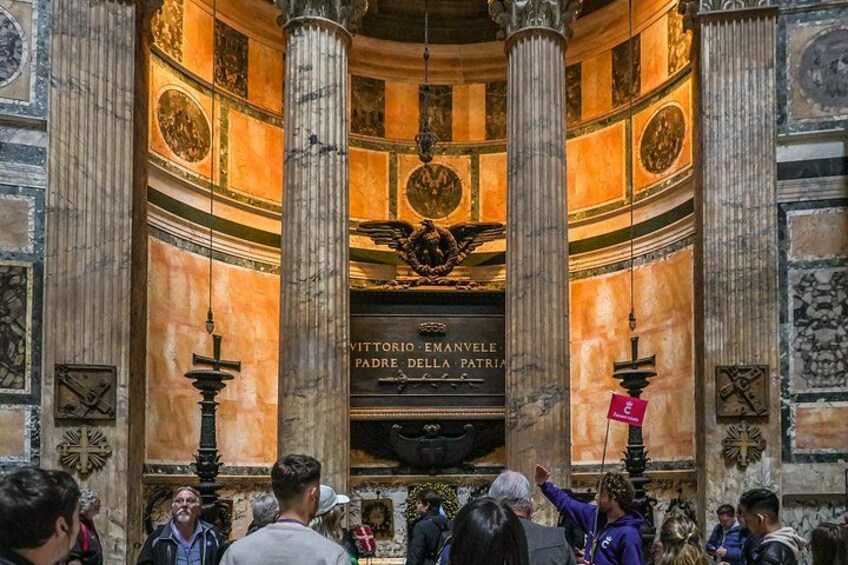 An interior with columns, a central altar, and a crowd of people. 2