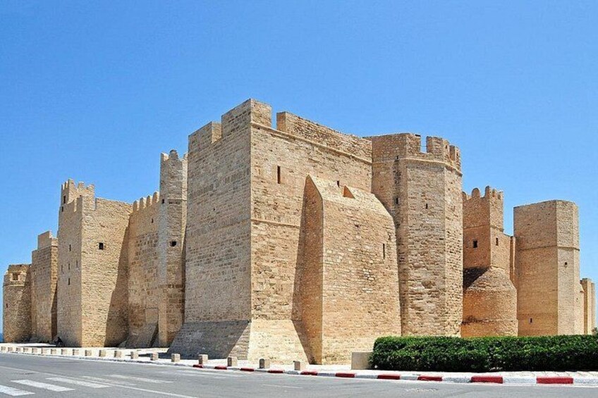 A large stone castle with multiple towers and arched windows. 2