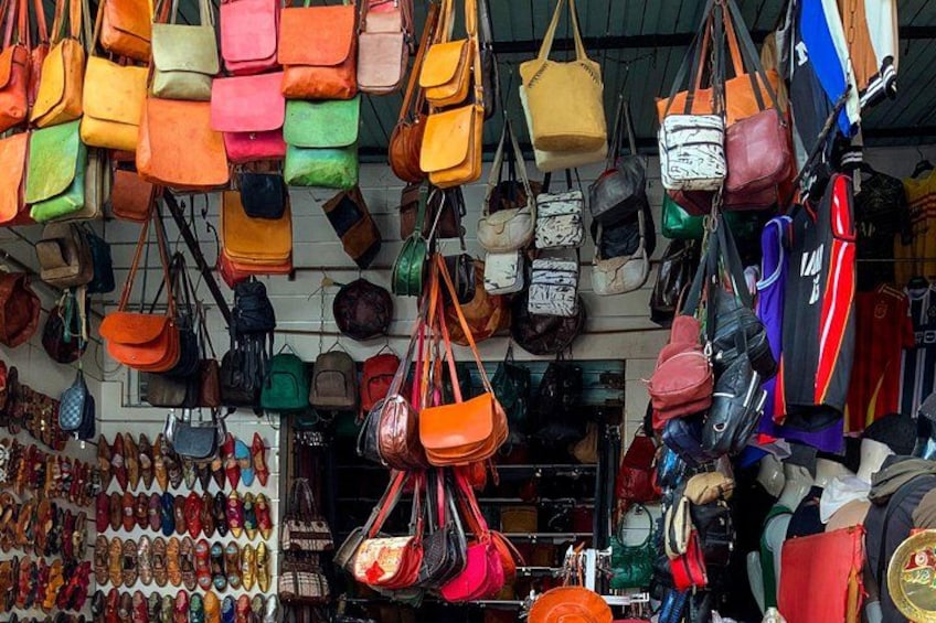 A variety of handbags hanging in a store. 4