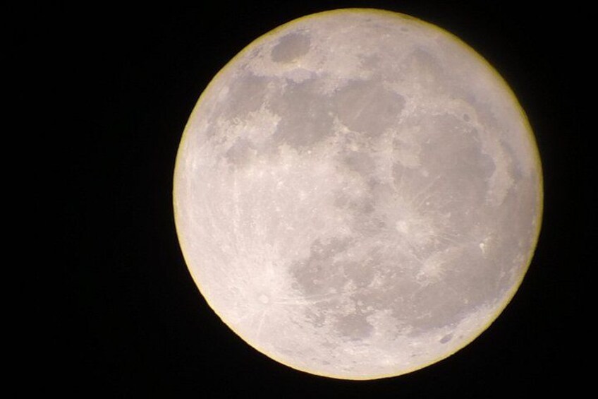A full moon with visible craters and maria against a black sky. 2