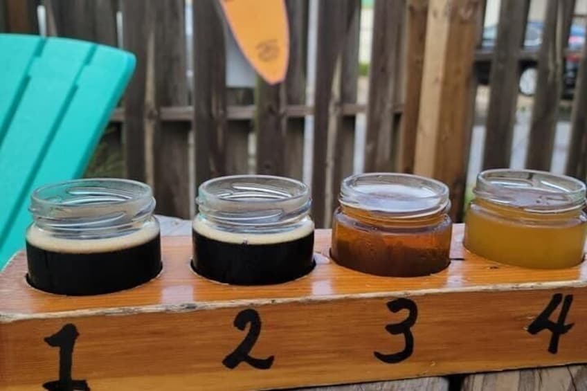 Four jars of liquid on a wooden board with numbers 1 to 4. 4