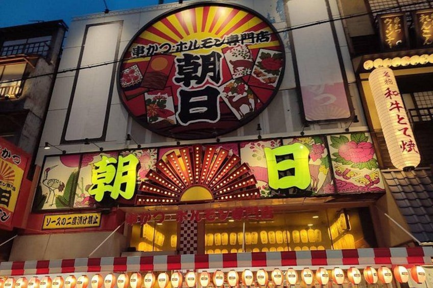 En butik med lyse neonskilte og traditionelle japanske lanterner. 4