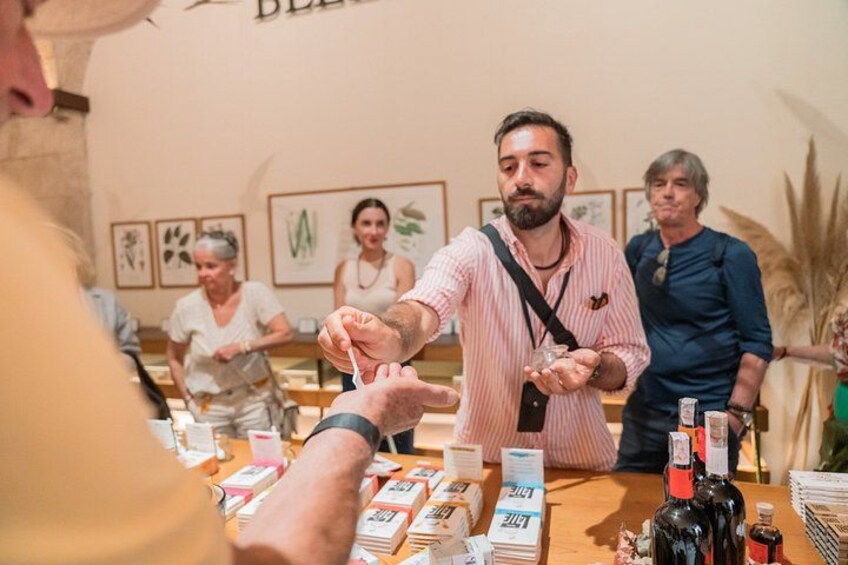 A person pouring a drink from a bottle into a glass. 2
