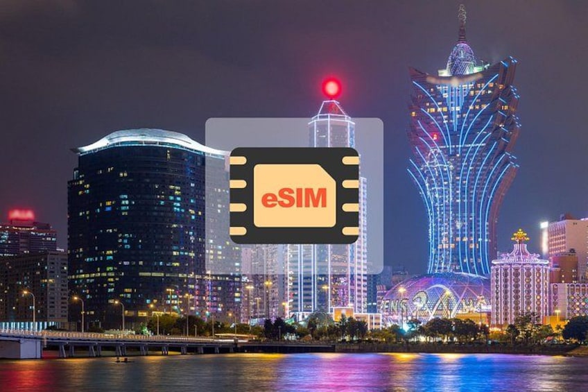 A cityscape at night with illuminated buildings and a prominent tower. 1
