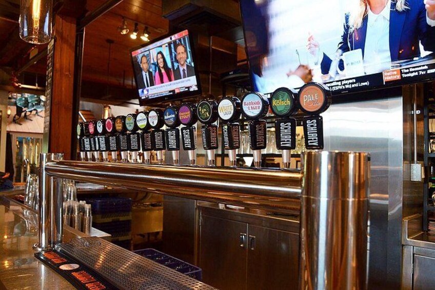 A bar with a tap system and a television screen. 2