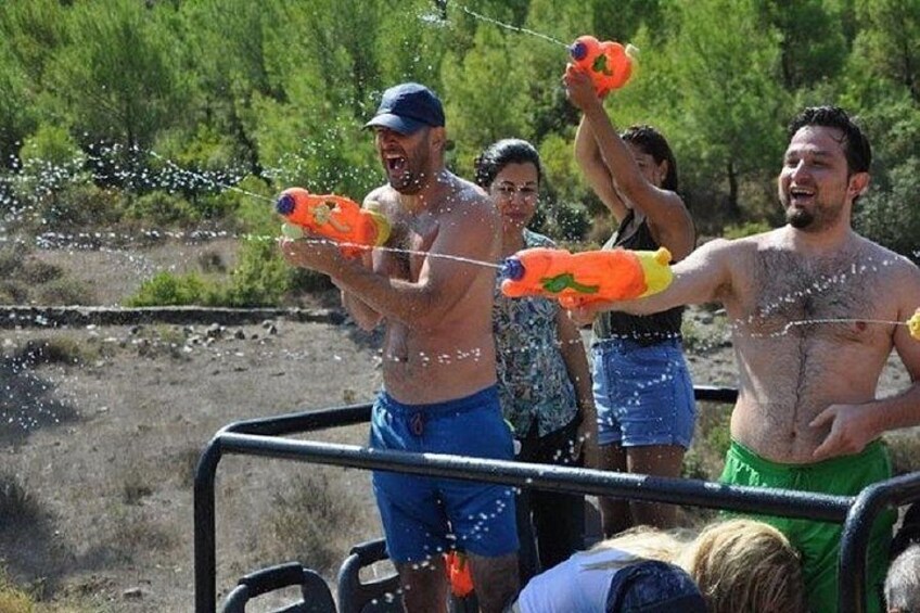 People playing with water guns in an outdoor setting. 5