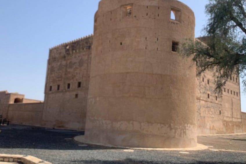 A large, circular stone fortress with multiple windows and a flat roof. 3