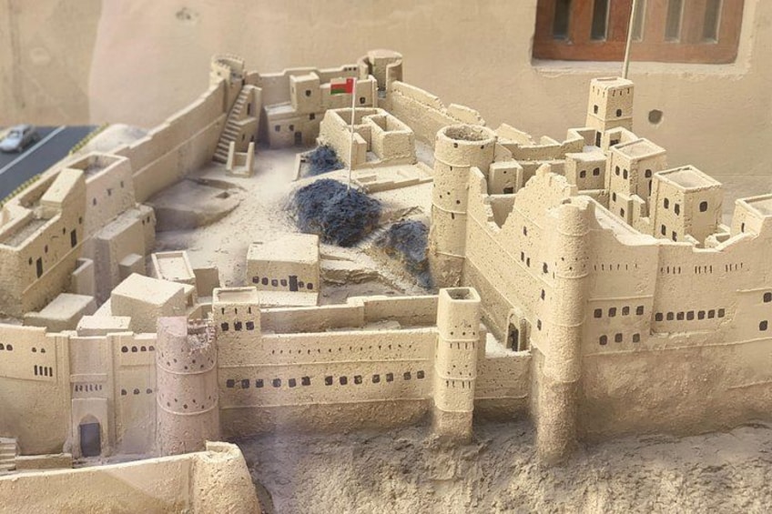 A detailed model of a fortified city with multiple towers and walls. 5