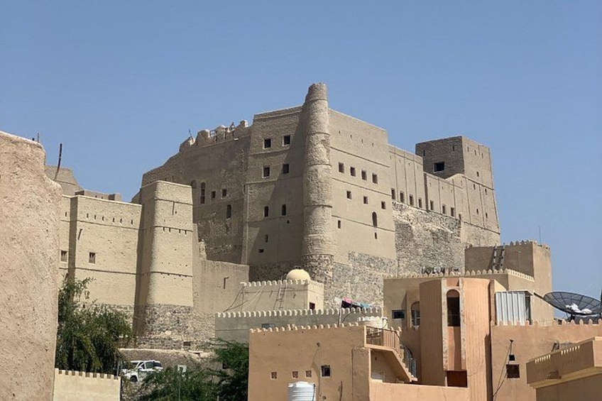 A large fortress-like structure with multiple towers and walls, surrounded by other buildings. 2