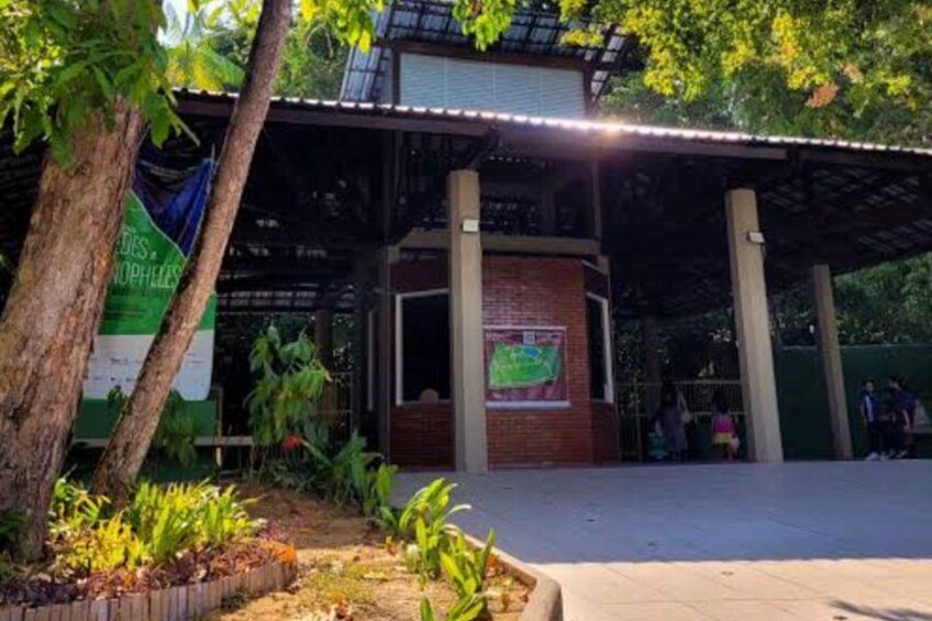 A covered outdoor area with a brick wall, a map, and a banner. 1