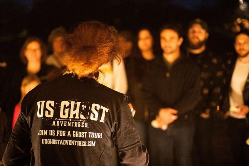 A person wearing a black jacket with text on the back. 3
