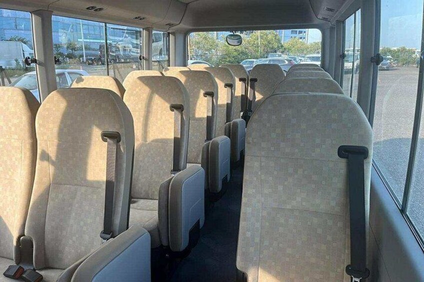 The interior of a bus with rows of seats and windows. 2
