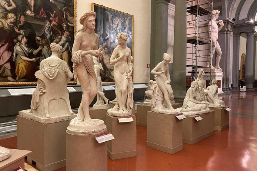 Marble sculptures in a museum with classical themes, displayed on pedestals. 3