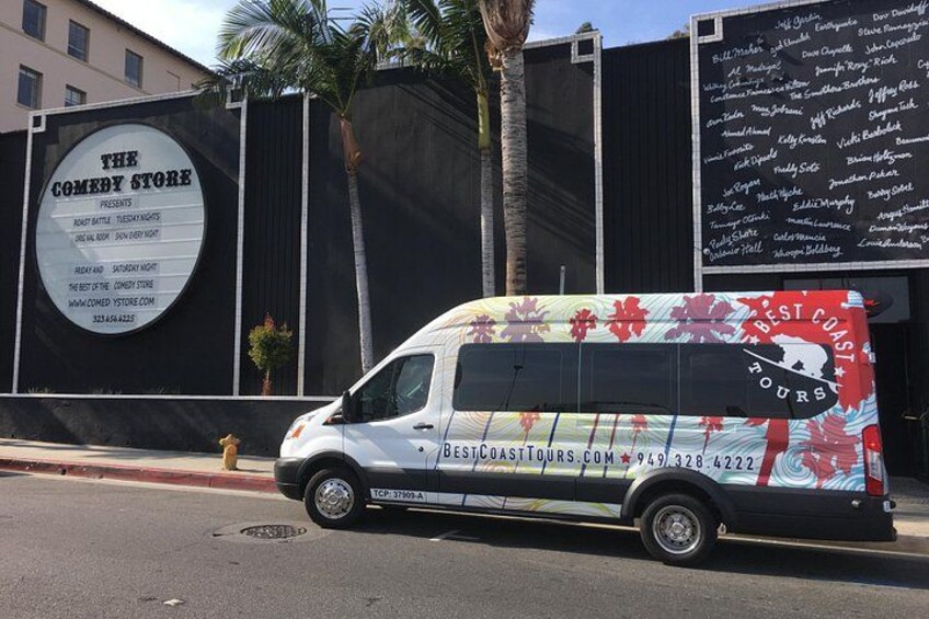 Una camioneta blanca con gráficos rojos y negros estacionada en la calle. 3