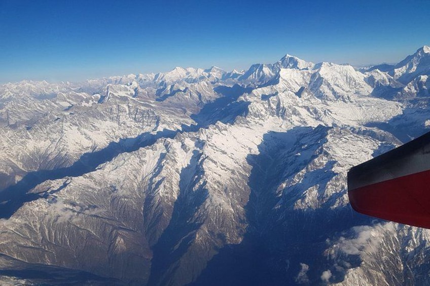 A snow-covered mountain range with a clear sky. 2