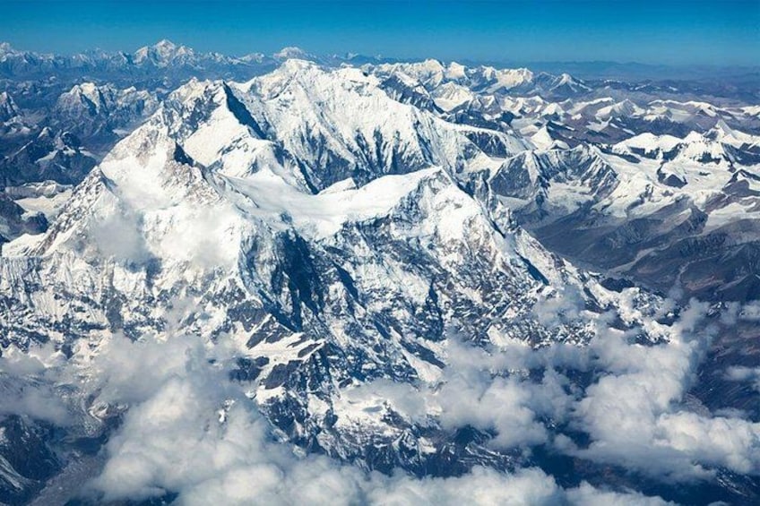 A snow-covered mountain range with sharp peaks and valleys. 5