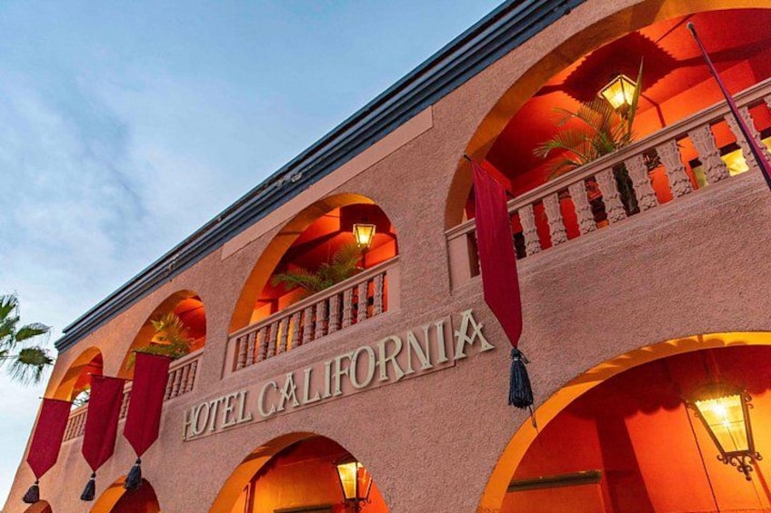 A hotel facade with arched windows and balconies, and the name 'HOTEL CALIFORNIA' prominently displayed. 5