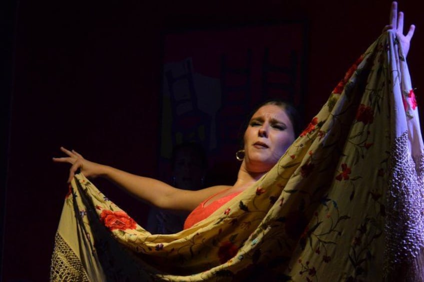 A person holding a patterned fabric. 1