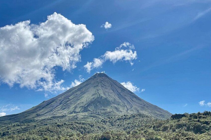 A volcano with a clear sky and clouds. 2