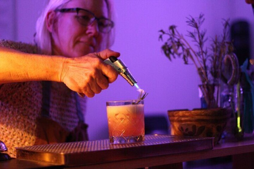 A person pouring a drink into a glass. 2