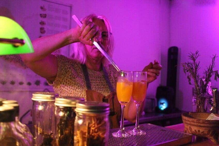 A person pouring a drink into a glass. 5