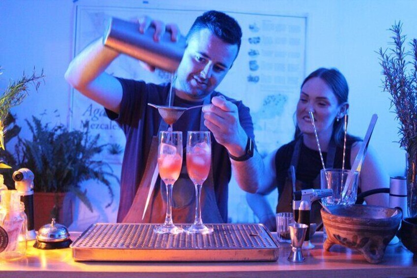 A bartender pouring drinks into glasses at a bar. 4