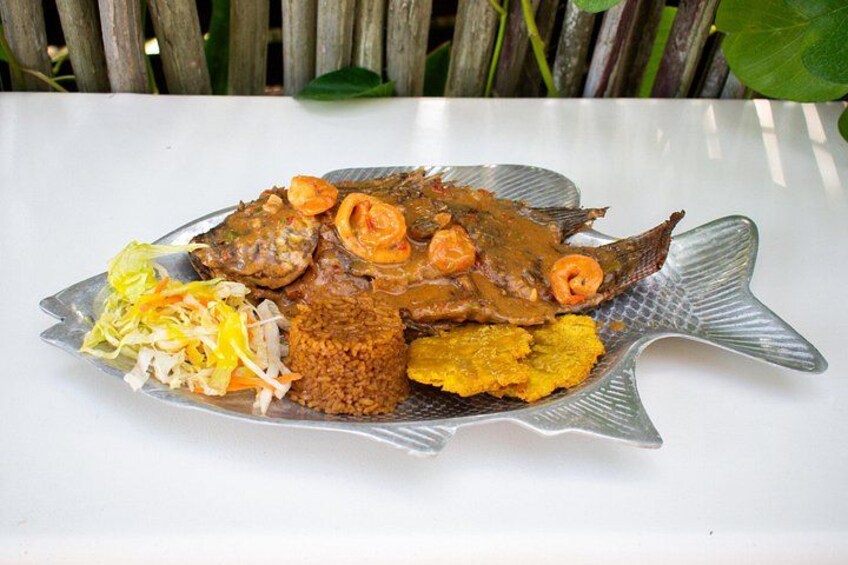 A fish-shaped plate with a whole fish, rice, and vegetables. 4